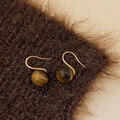 Detailed close-up of golden tiger eye stone drop earrings on warm brown velvet texture - 10mm Tiger's Eye Ear Hook