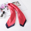 Detail of red silk scarf with white chevron stripes and navy border on a white table - Red Stripe (FL8-2)