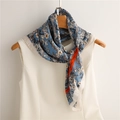 Close-up of floral silk scarf with orange hem and Happy New Year text detail - Blue Orange Floral Holiday Style (FJ584-2)