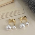 Detalle de pendientes de perlas blancas con cadena dorada sobre fondo vintage - Dorado con perla blanca