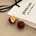 Macro detail of wine red cherry earrings showing the gold hammered inner texture - Wine Red Ball Stud Earrings - Gold Plated (A-31)