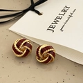 Close-up of vintage knot earrings in gold finish with deep red glazed enamel centers - Red Concentric Knot Stud Earrings - Gold Plated (A-303)