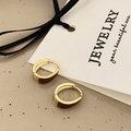 Detail of gold-tone metal earrings with brown enamel finish on a jewelry card - Coffee Enamel Huggie Earrings (A-57)