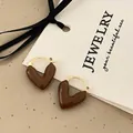Macro detail of French vintage heart earrings with brown enamel and golden metal - Coffee Heart Earrings (A-852)