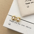 Detailed shot of freshwater pearl earrings with irregular gold-toned metal base design - Pea Stud Earrings / Gold