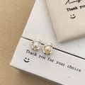 Detailed view of silver lava-textured earrings with white freshwater pearls on a gift box - Pea Stud Earrings / Silver