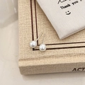 Close-up of elegant white pearl earrings on vintage book and canvas gift bag background - 6mm Shell Pearl Stud
