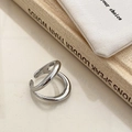 Detail of silver dual-layer crossover ring with high-polish finish on a beige background - Bold Open Double Layer Ring / Silver