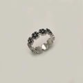 Macro detail of silver floral ring featuring black enamel petals and vintage minimalist design - Black Flower Silver Open Ring