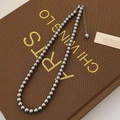 Close-up of elegant silver-grey pearl necklace with adjustable lobster clasp and chain - High Luster Grade / 6mm