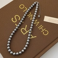 Close-up of elegant dark grey pearl necklace with adjustable silver extension chain - High Luster Grade / 8mm