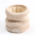 Detail of beige knitted neck warmer with thick fleece lining and white logo embroidery - Apricot