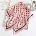 Pink polka dot silk square scarf 90cm with black border shown in elegant lifestyle setting - 90x90cm / Pink