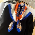 Close-up of silk scarf with royal chain patterns tied on a black sweater for elegant styling - 70x70cm / Royal Blue Border