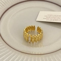 Detailed macro shot of a gold textured ring with micro-set zircons and a ribbed design - Gold