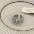 Close-up of silver adjustable ring with vertical wave texture and three vertical zircons - Silver