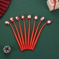 Set of 8 red Christmas pens with Santa Claus toppers on festive green background - Red Series (Santa Claus) / 0.5mm