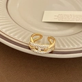 Macro shot of gold pig nose open ring featuring white pavé zircons and a double-layer design - Gold