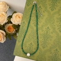 Detail of malachite green beaded necklace with center pearl on vintage floral pattern - Swarovski Pearl Pendant Turquoise Beaded Necklace