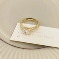 Detailed macro view of gold plated adjustable ring with large round micro-set zircon stone - Gold Micro-Inlaid Zirconia Style