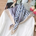 Detail of silk scarf with geometric cube patterns paired with a white shirt - 70*70cm / Khaki Edge