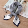 Close-up of a tied houndstooth silk scarf in navy and white on a wooden background - Navy Blue / 70*70cm
