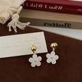 Detail view of French floral drop earrings with white petals and golden accents - White Flower Studs