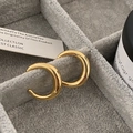 Close-up of chunky gold C-shaped hoop earrings on a grey velvet jewelry display tray - Gold Small (Real Gold Plated)