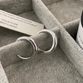 Macro shot of silver crescent hoop earrings with mirror-polished finish on jewelry display - Silver Small (Real Gold Plated)