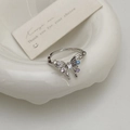 Detailed macro of silver butterfly ring featuring colorful zircon stones on ceramic plate - Silver Butterfly Open Ring