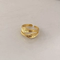 Macro detail of golden irregular lava texture and ripple design on an open ring - Gold Irregular Open Ring