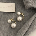 Detail view of French-style double pearl earrings with gold U-shaped metal studs - Pearl White