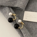 Detail of French minimalist stud earrings with gold metal and contrast black and white beads - Black and White