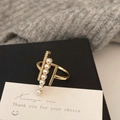 Primer plano de un anillo dorado con perlas degradadas y circonitas en caja de regalo - Dorado