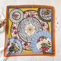 Flat lay of silk scarf featuring floral umbrella patterns and bright orange borders - Fj464-3 / 70*70cm