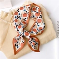 Detail of fall-themed silk scarf with pumpkin print tied on a pleated beige shirt - Pumpkin (LX 14)