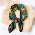 Detail of silk scarf with leopard and tropical leaf print tied on pleated beige fabric - Leopard (LX 15)