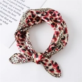 Close-up of knotted red and black leopard print satin scarf with elegant silk texture - 60x60cm / Red
