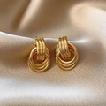 Close-up of golden multi-layer hoop earrings on champagne silk fabric background - Gold Multi-Layer Circle Stud Earrings