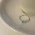 Detail of twisted silver band ring with a round light blue cat eye stone inlay - Light Blue Cat's Eye Twisted Rope Open Style (Cat's Eye Open Ring)