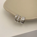 Detailed view of silver ear cuffs set with micro-pave zircons on a ceramic plate edge - C-Shape Micro-set Zirconia Silver Ear Cuff (A-138)