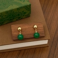 Détail de boucles d'oreilles boules dorées avec gouttes en calcédoine verte sur bois - Boucles d'Oreilles Pendantes Dorées en Calcédoine Verte (A-115)