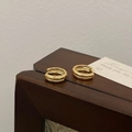 Close-up of golden double-hoop earrings with parallel grooves on a wooden display - Gold Plain Hoop Earring