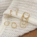 Five-piece gold star and moon earring set with cubic zirconia on white knit background - Star and Moon Earrings Set