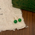 Detailed close-up of green chalcedony stud earrings with gold metal base on rustic paper - 6mm Green Chalcedony Stud Earrings