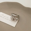 Close-up of a silver irregular textured open ring with minimalist liquid metal ripples - Silver Hollow Out