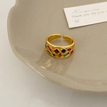 Detailed shot of open geometric ring with colorful square cubic zirconia in a tray - Gold Multicolor Zircon Open Ring