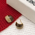Detail of two-tone burgundy and cream enamel earrings on soft red knit fabric texture - Coffee and Milk Tea