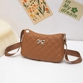 Brown quilted shoulder bag featuring golden bow detail and wide textile strap - Tan