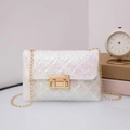 Detailed close-up of iridescent sequin crossbody bag with gold chain and metal buckle - Pink